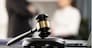 Focus closeup wooden gavel on blurred background of lawyer colleagues or legal team working at law firm office. Hammer of justice for righteous and equality judgment. Equilibrium