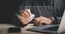 Closeup of businessman hand with stylus signing digital documents. Embracing digital transformation, this stock photo represents efficient business contract signing. Paperless office is focus.