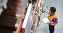 Worker with scanner making review of goods in warehouse