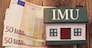 house with euro banknotes with the sign "Imu" italian tax