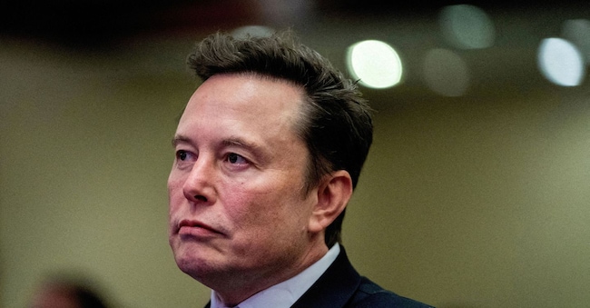 FILE PHOTO: FILE PHOTO: Tesla CEO and X owner Elon Musk listens as US President-elect Donald Trump speaks during a meeting with House Republicans at the Hyatt Regency hotel in Washington, DC, U.S. on November 13, 2024.  ALLISON ROBBERT/Pool via REUTERS/File Photo/File Photo