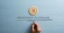 Letter R cut into wooden cut circle and male hand writing a Registered trademark sign under it. Over pastel blue wooden background.