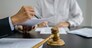 Legal counsel presents to the client a signed contract with gavel and legal law. justice and lawyer concept.