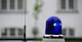 blue police light shining on an old police car in Denmark