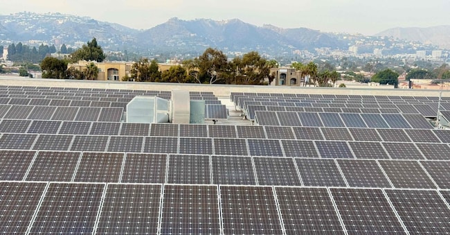 Solar panels are seen on the roof of a commercial building in West Los Angeles, on January 4, 2025. (Photo by Daniel SLIM / AFP)