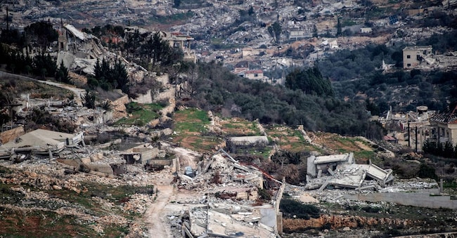 Israeli military vehicles drive past destruction in southern Lebanon,  after a ceasefire between Israel and Hezbollah took effect. January 26, 2025.