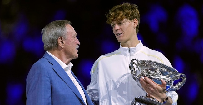 John Newcombe (7 titoli slam in singolare) ha appena premiato Jannik Sinner (3) con  il suo 2° trofeo  degli Australian Open il 26 gennaio 2025 (AP Photo/Ng Han Guan)