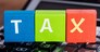 Close-up Of Colorful Blocks With Word Tax Placed Over Calculator