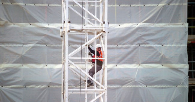 Worker on crane at site
