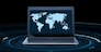 business and future technology concept - world map on laptop computer screen over black background