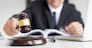 Male Judge lawyer In A Courtroom Striking The Gavel on sounding block.