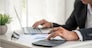 Asian businessman hands calculating number, graph, chart audit planning accountancy on business report. Asian professional Business man hands using calculator counting tax financial bill. Tax audit Finacial concept.