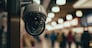 Close - up of a security camera monitoring of a busy shopping center created by generative AI