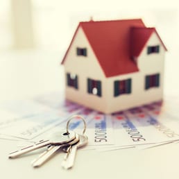 mortgage, investment, real estate and property concept - close up of home model, money and house keys