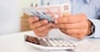 Male hand computer calculator money pen