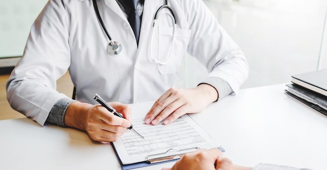 Doctors and patients consulting and diagnostic examining sit and talk. At the table near the window in the hospital medicine concept