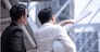 Asian businessman discuss with engineer architect in suite, looking and point to finger forward away and holding construction roll plan for working team concept,back view