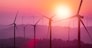 Wind turbines silhouette on mountains at sunset. Concept of renewable clean energy and sustainability development business from wind energy.