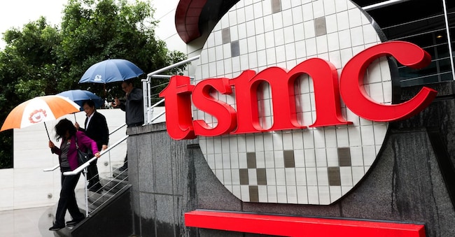 (FILES) People walk beside Taiwan Semiconductor Manufacturing Company (TSMC) signage outside the company's Museum of Innovation at its headquarters in Hsinchu on November 21, 2024. US President Donald Trump's threat of tariffs on semiconductor chips has complicated Taiwan's bid to remain a global powerhouse in the critical sector and stay onside with key backer Washington, analysts said. (Photo by I-Hwa CHENG / AFP) / To go with AFP story Taiwan-US-semiconductors-economy-diplomacy, FOCUS by Allison Jackson