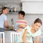 Parents and their four kids cleaning up their kitchen room together