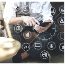 Justice and Law context.Male lawyer hand sitting on sofa and working with smart phone,digital tablet computer docking keyboard with gavel and document on living table at home,virtual interface graphic icons diagram