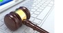 Online judgement. Gavel on laptop. Conceptual image. 3d