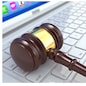 Online judgement. Gavel on laptop. Conceptual image. 3d