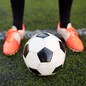 sport, football and people - soccer player playing with ball on field