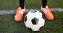 sport, football and people - soccer player playing with ball on field