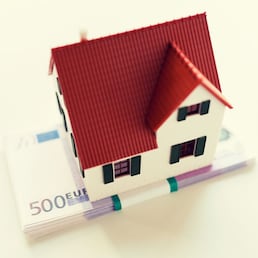 building, mortgage, investment, real estate and property concept - close up of home or house model and money