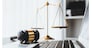 Symbolizing justice and legal authority, golden balanced scale and gavel on desk with laptop in law office background, reflecting concept of equality and fair judgment by lawyer and judge. equility