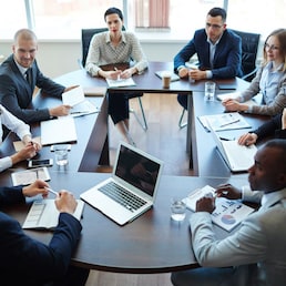 Businespeople at panel discussion in board room