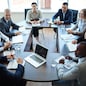 Businespeople at panel discussion in board room