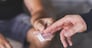 Drug dealer selling ecstasy pills to a drug addict