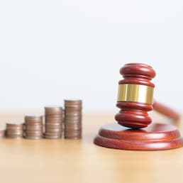 judge gavel with money coins stack on desk. Law cost, lawyer, judgment, justice auction and bidding concepts
