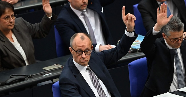 Friedrich Merz, leader della Cdu, alza la mano durante la votazione al Bundestag (AFP)