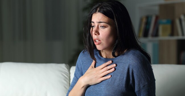 Woman suffering an anxiety attack alone in the night