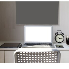 blank screen laptop computer and smart phone and digital tablet and stylus pen is on wooden desk as workplace concept