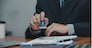 Man stamping approval of work finance banking or investment marketing documents on desk.