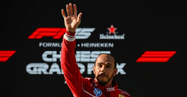 TOPSHOT - Ferrari's British driver Lewis Hamilton waves as he celebrates taking pole position after the sprint qualifying session of the Formula One Chinese Grand Prix at the Shanghai International Circuit in Shanghai on March 21, 2025. (Photo by GREG BAKER / AFP)