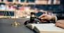 Closeup lawyer or attorney preparing for lawsuit or litigation, reading or studying on legal book on his desk at library for educational law school concept, decorated with legal symbols. Equilibrium