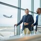 Travel for business, team at airport and men, catch flight for work trip with conference or training seminar with accountant. Walk, talk and diversity with finance convention and partnership