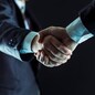 closeup of a business handshake partners.photo on a black background and has space for your text.
