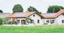 Renewable energy system on roof of traditional houses in contemporary suburban neighborhood in Italy, Europe. Modern and beautiful houses in european style with solar panels on the roof.