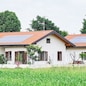 Renewable energy system on roof of traditional houses in contemporary suburban neighborhood in Italy, Europe. Modern and beautiful houses in european style with solar panels on the roof.