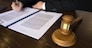 Lawyer working with contract papers on the table in office. consultant lawyer, attorney, court judge, concept.