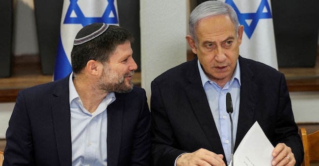 FILE PHOTO: Israeli Prime Minister Benjamin Netanyahu speaks with Minister of Finance Bezalel Smotrich  during  the weekly cabinet meeting at the Defence Ministry in Tel Aviv, Israel, January 7, 2024. REUTERS/Ronen Zvulun/Pool/File Photo