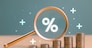 Interest rate rise, dividend money investment concept. Business provision of financial service. Gold magnifying glass finding on house loan interest rate percentage icon, mortgage rate blue background