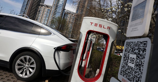 A Tesla car charges at a Supercharger charging station of the electric vehicle (EV) maker in Beijing, China March 24, 2025. REUTERS/Florence Lo