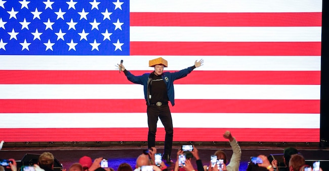 Elon Musk wears a cheesehead during a town hall Sunday, March 30, 2025, in Green Bay, Wis. (AP Photo/Jeffrey Phelps)